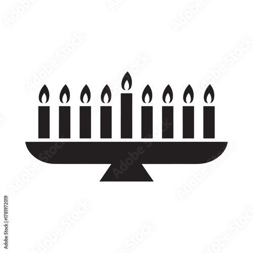 Black silhouette of a menorah with nine lit candles on a white background