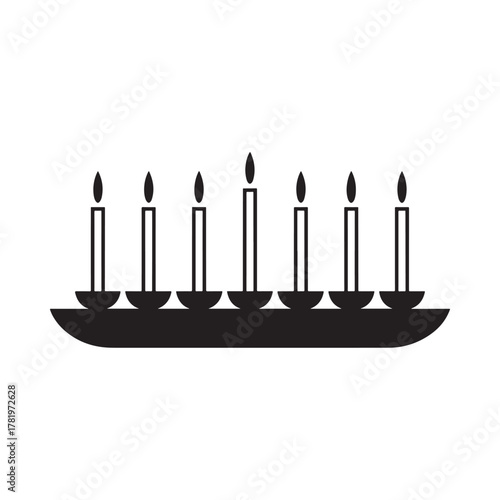 Silhouette of a candelabra with seven lit candles on a dark background