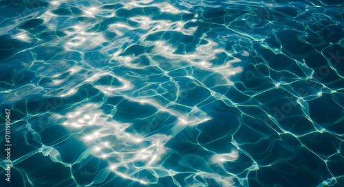 Fototapeta Naklejka Na Ścianę i Meble -  Sunlight reflecting on the surface of clear blue water