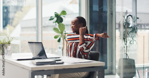 Laptop, business woman and stretching in office to start work, productivity and budget review. Finance manager, black person and online tutorial at desk for muscle relief, posture or financial report