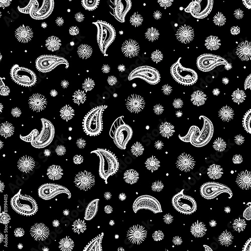 Handdrawn white paisley patterns and asterisk floral ornaments scattered on a black background beautifully