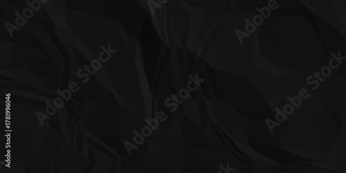 Black crumpled paper creased grunge texture. Paper wrinkled surface glued paper poster background. Crumpled and top view textures can be used for background of text or any contents.	