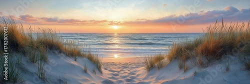 peaceful sandy beach between tall grass dunes overlooking calm ocean waves during vibrant sunset with colorful sky