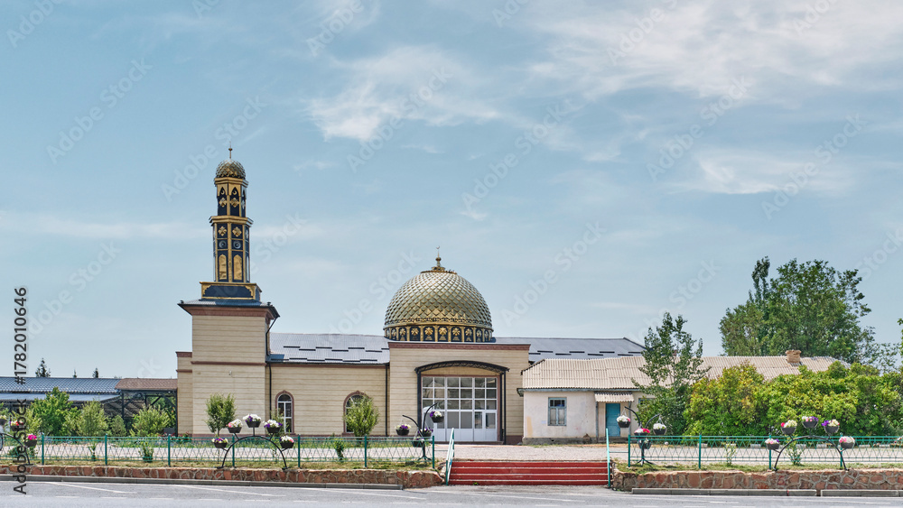 Obraz premium Modern mosque with golden dome and minaret in Cholpon-Ata, Kyrgyzstan