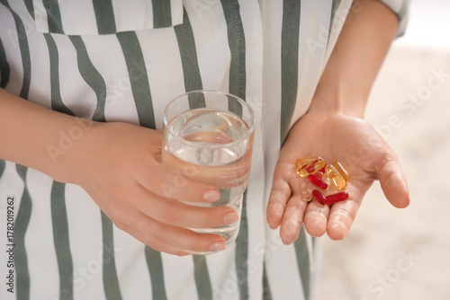 Woman with pile of vitamin ...