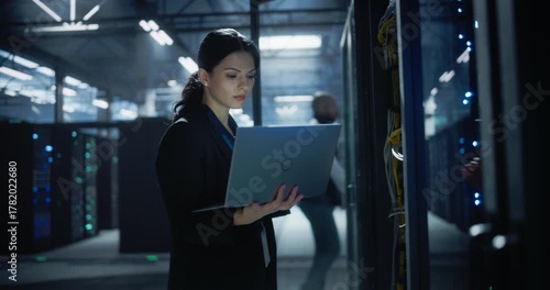 Wallpaper Mural Female Administrator Working on Laptop in Data Center. Torontodigital.ca