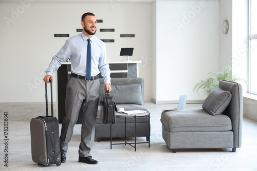 Young businessman with bags...