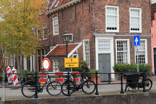 Leiden Street View with Parked Bicycles, Autumn Foliage and Brick House Facades, Netherlands