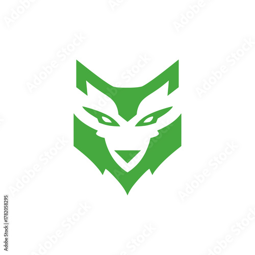 Modern green geometric wolf head icon on white background. Stylized canine animal symbol, abstract fox or dog vector illustration.
