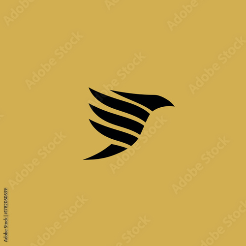 Elegant black abstract bird silhouette icon with open wings, flying dynamically on a sophisticated golden background. Minimalist modern avian design.