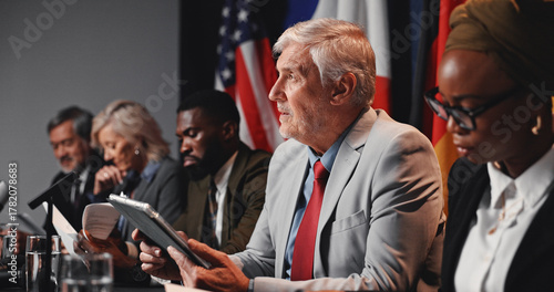 Фотография Press conference, tablet and man with group for delegation, international government and panel