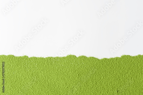 Flat layer of vibrant green matcha powder aligned horizontally over clean white surface creates bold contrast and minimalist mockup