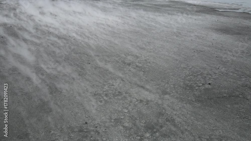 Aerial view of a windswept field, the wind creating swirling patterns and textures across the landscape, Yogyakarta, Yogyakarta, Indonesia.