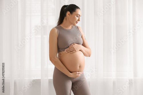 Sporty young pregnant woman...