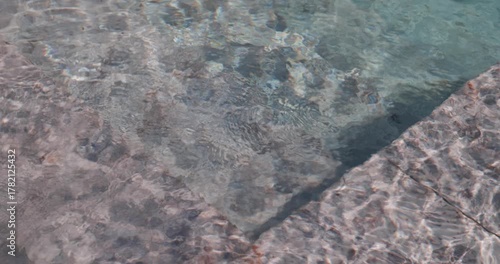 Triangular composition of stones in the shallow part of a swimming pool