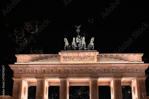 Berlin, Germany:  Brandenburg Gate framed by floating soap bubbles at night. Symbol of Berlin and German division during the Cold war era. Brandenburger Tor. 