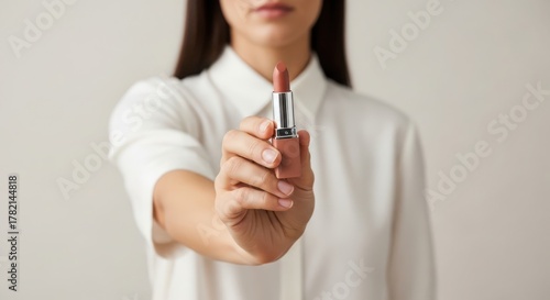 Wallpaper Mural Woman holding a lipstick isolated on white background Torontodigital.ca