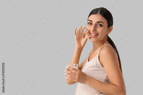 Young woman with vitamin E ...