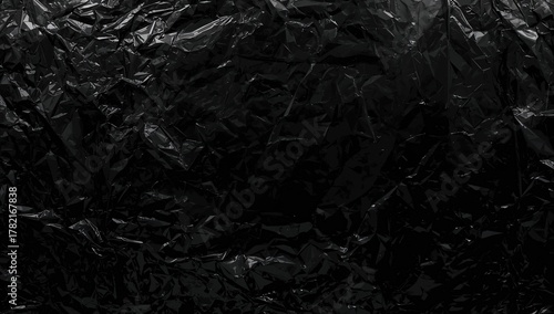 Black background with wrinkled plastic wrap texture, suitable for editorial design