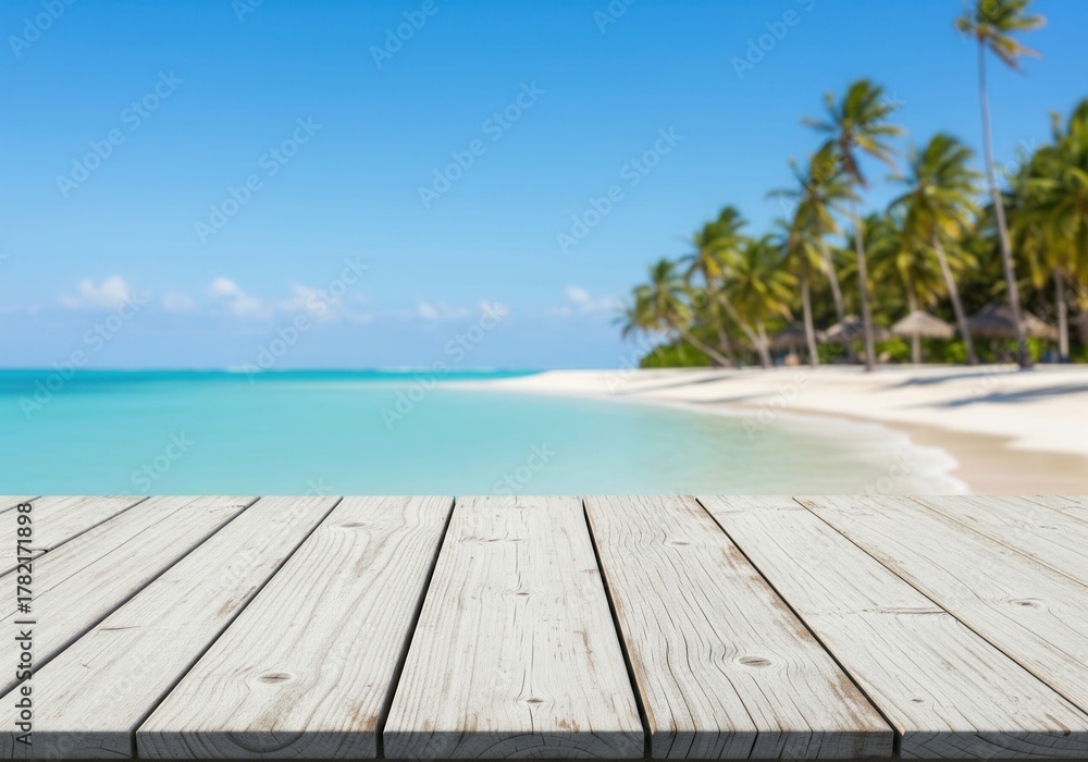Fototapeta premium Distressed white wood table overlooking a tropical beach with turquoise ocean and palm trees