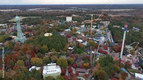 Aerial view of Kings Dominion Amusement Park and Water Park in Soak City, Virginia. Wide shot. Multicolored trees in fall season. Orbit wide shot.