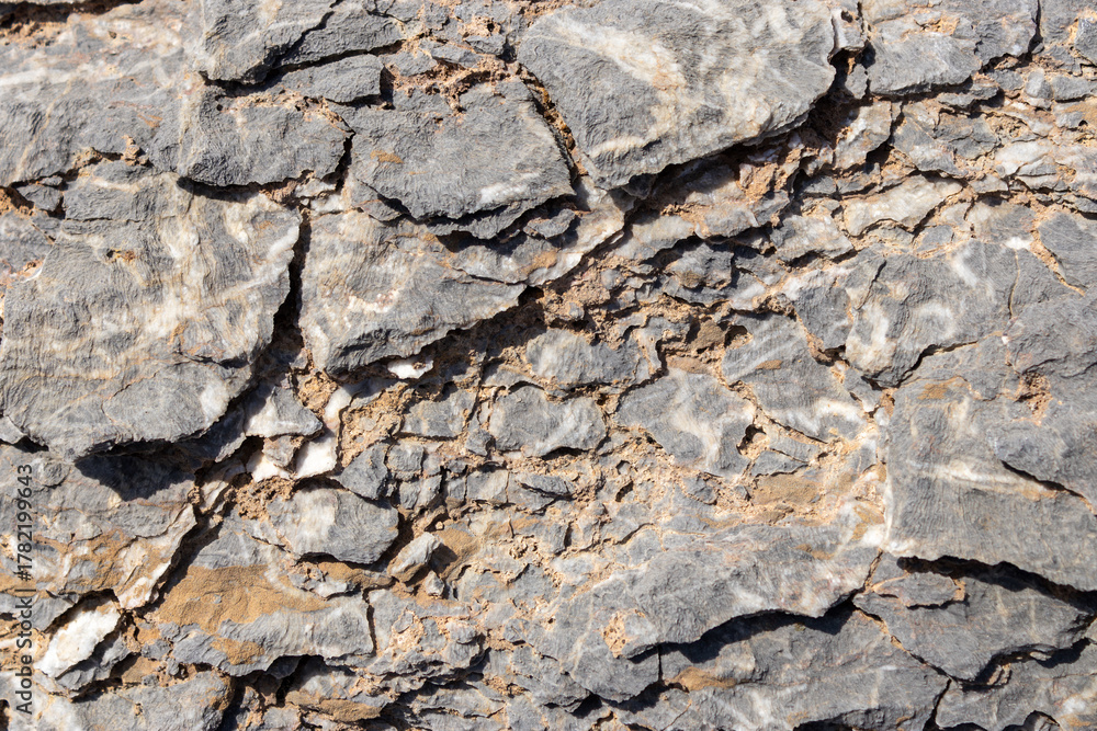 Fototapeta premium Natural texture background of fractured grey rock and stone surface.