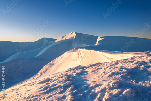 magical sunrise on a mountain peak. snowy Mountain peaks. fairytale calming landscape