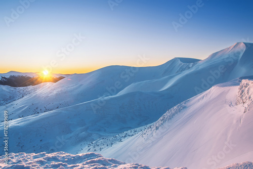 magical sunrise on a mountain peak. snowy Mountain peaks. fairytale calming landscape