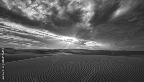 Fototapeta Naklejka Na Ścianę i Meble -  Dramatic sky above sandy dunes, emphasizing erosion risk