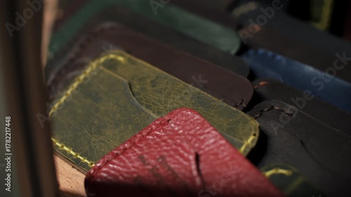 Stack of colorful stitched leather wallets