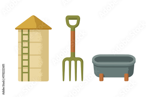 Tall grain silo, green pitchfork, and animal feeding tub used in agriculture