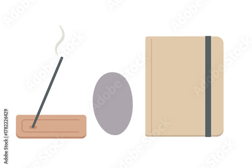 Minimalist composition of incense stick, smooth stone, and journal for self-care and meditation practice