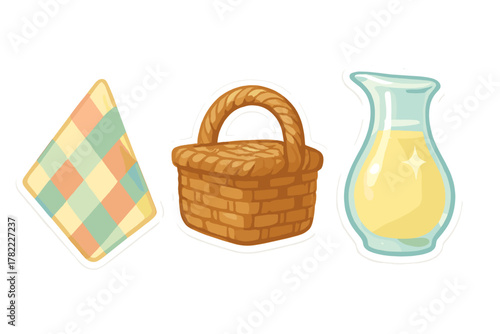 Picnic essentials set including a checkered blanket, woven basket, and glass pitcher with lemonade
