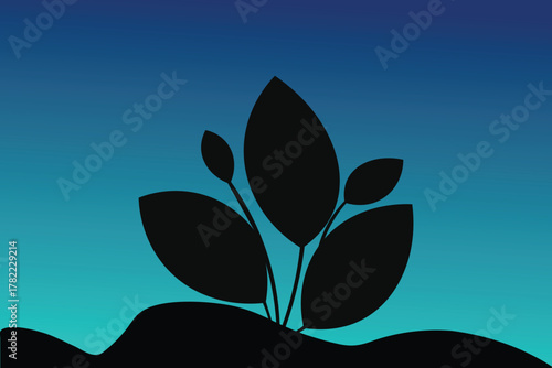 Silhouette of a plant growing from the ground against a gradient sky