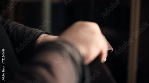 Hands rolling leather belt in workshop