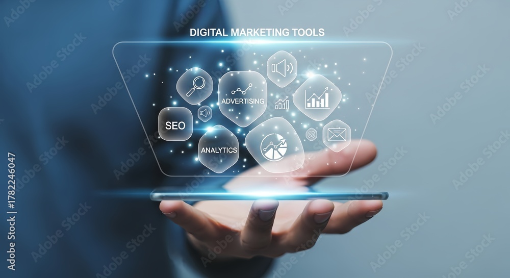 Fototapeta premium Hand holding a phone displaying digital marketing tools in a holographic interface