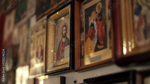 Wall with framed religious icons in soft light