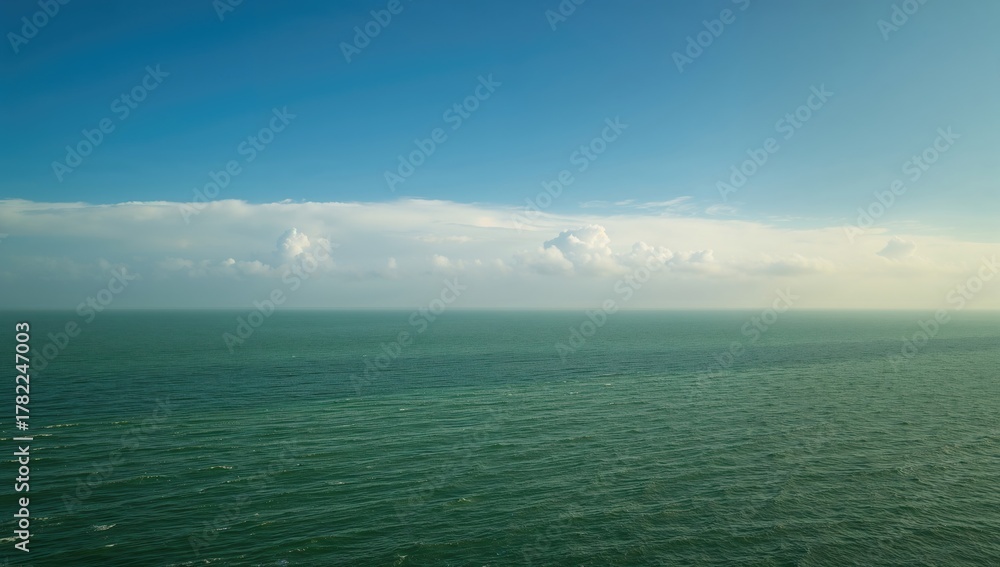 Obraz premium Emerald Ocean and Ivory Skies, seasonal change