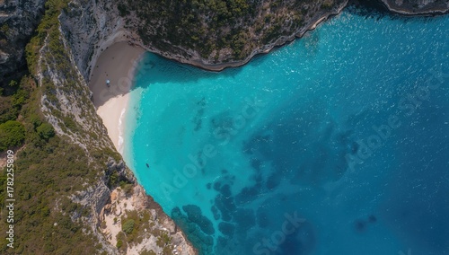 Fototapeta Naklejka Na Ścianę i Meble -  Aerial view of the sea, showcasing natural beauty with bright blue waters and rocky mountains, ideal for editorial header background