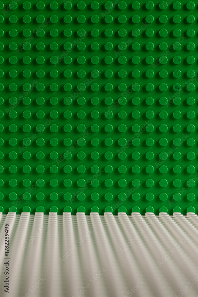 Naklejka premium Green and White LEGO Baseplates Building Background Perspective