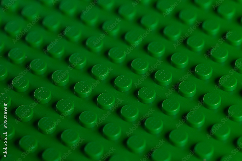 Fototapeta premium Vibrant Green LEGO Baseplate Top View Seamless Pattern