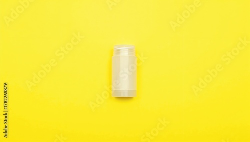 Wallpaper Mural An empty plastic deodorant container on a vibrant yellow backdrop, suitable for layout and design Torontodigital.ca