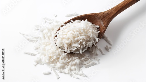 Heap of coconut flakes in a wooden spoon, fiber-dense choice