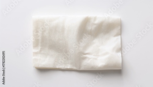 Wallpaper Mural Single folded napkin on a plain white surface Torontodigital.ca