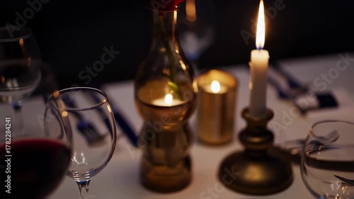 An Intimate Candlelit Dinner Setting with Wine and Elegant Tableware.