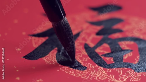 Artist Writing Chinese Calligraphy Fu Character for Good Fortune.