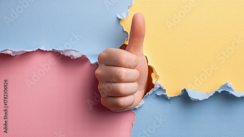 Thumbs Up Hand Gesture Emerging Through Torn Paper Background. Symbol For Approval, Positivity, Feedback, Success, Graphic Design And Branding