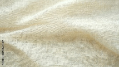 close-up of soft beige fabric with natural textured weave and gentle folds creating a calm and warm atmosphere