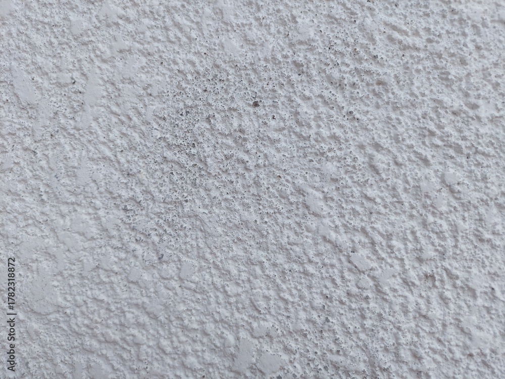 Fototapeta premium Create elegant designs with this cool white textured wall background for websites and advertising