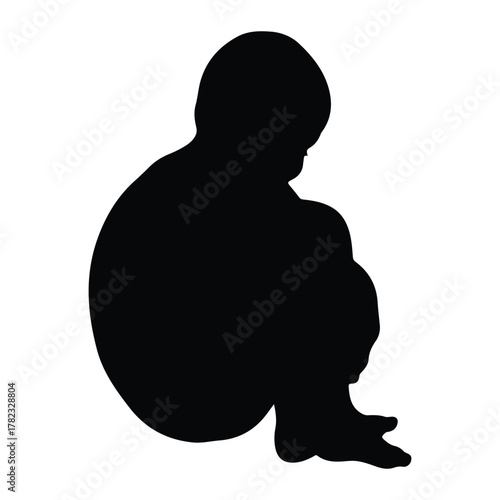 Silhouette of a child sitting in a fetal position baby